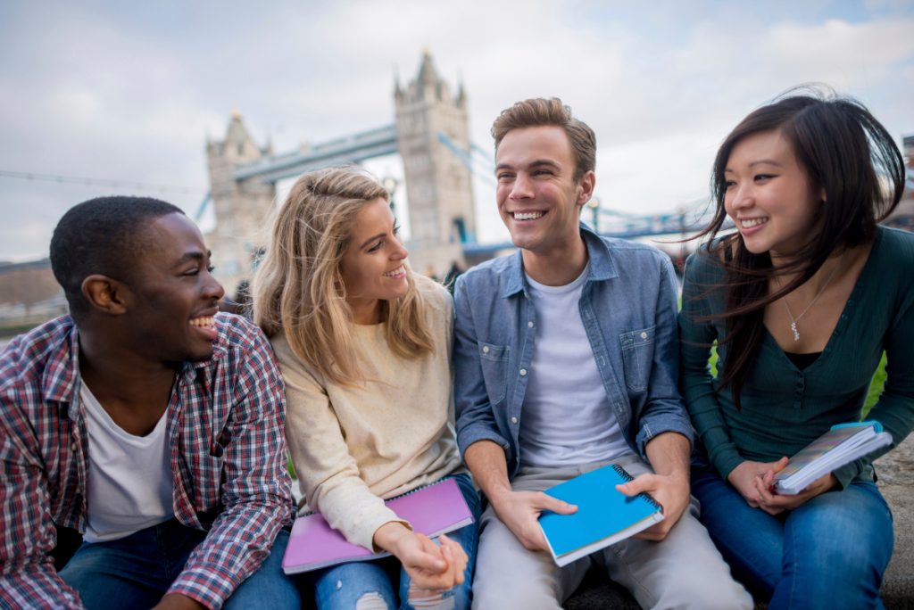Happy group of students studying in London